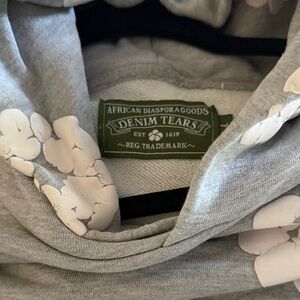 Denim Tears Gray Hoodie with White Floral Design